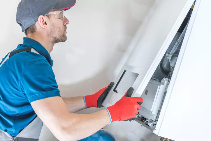 A professional technician installing a new heating system