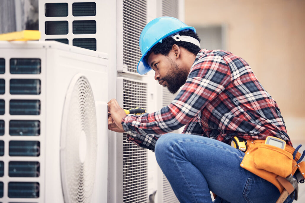 A technician repairing a Heat Pump