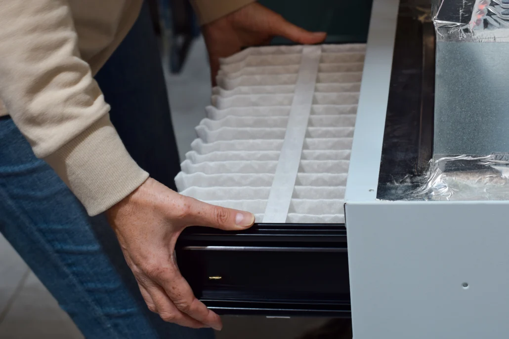 A professional technician replacing a Furnace filter