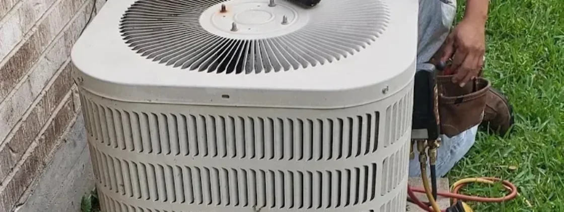 Technician inspecting air conditioning components for cooling failures